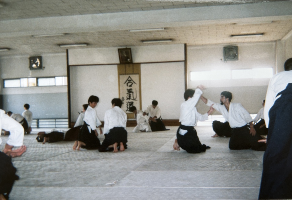 Trainingseinheit in einem Aikido-Dojo mit mehreren Praktizierenden auf einer Tatami-Matte.