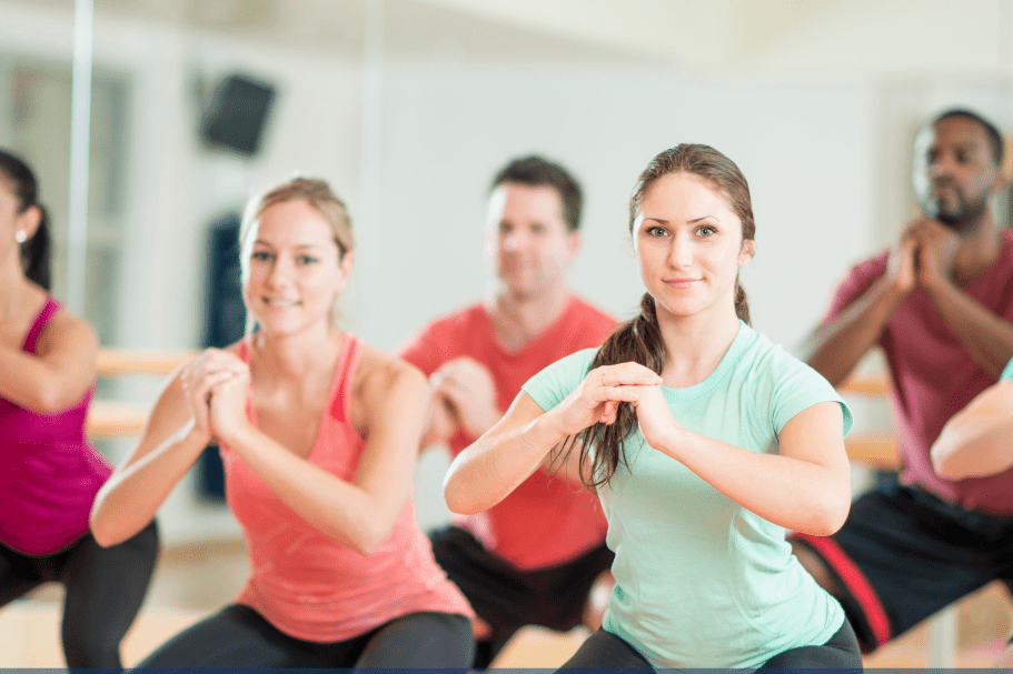 Gruppentraining in einem Fitnessstudio mit mehreren Personen, die &Uuml;bungen f&uuml;r Fitness und Gesundheit ausf&uuml;hren.