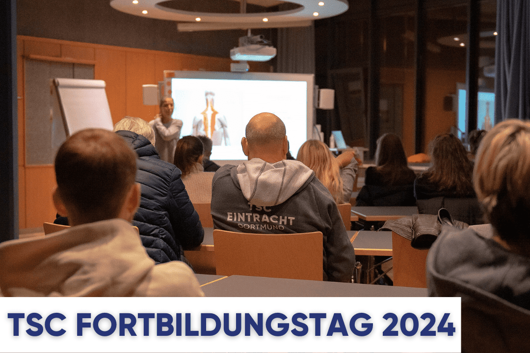 Gruppensitzung während des TSC Fortbildungstags 2024, Präsentation im Hintergrund, Teilnehmende in einem Seminarraum.