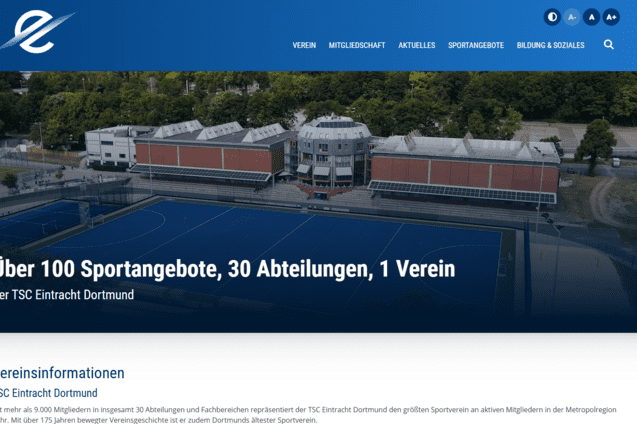 Luftaufnahme des TSC Eintracht Dortmund mit Sportpl&auml;tzen und einem modernen Vereinsgeb&auml;ude im Hintergrund.