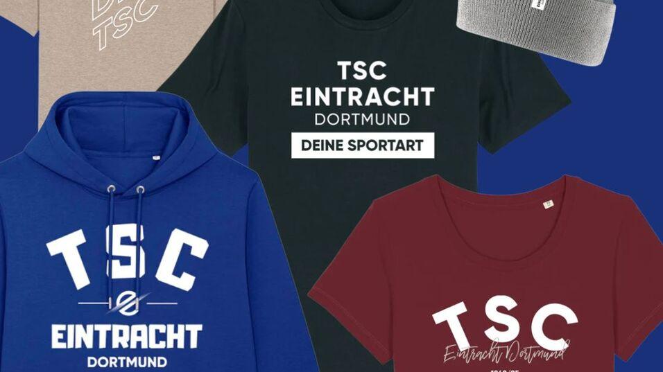 Kollektion von Bekleidung: Sweatshirt, T-Shirt, Shirt und Mütze mit TSC Eintracht Dortmund-Logo auf einfarbigem Hintergrund.