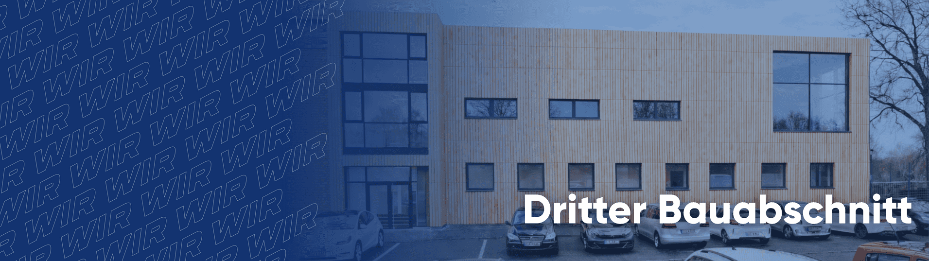 Fassade eines modernen Geb&auml;udes mit Holzverkleidung und Fenstern, beschriftet mit &bdquo;Dritter Bauabschnitt&ldquo;.